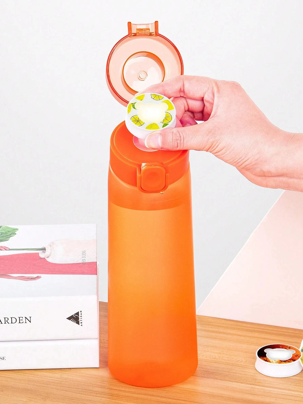 Orange air water bottle with open flip lid and inner cup shown