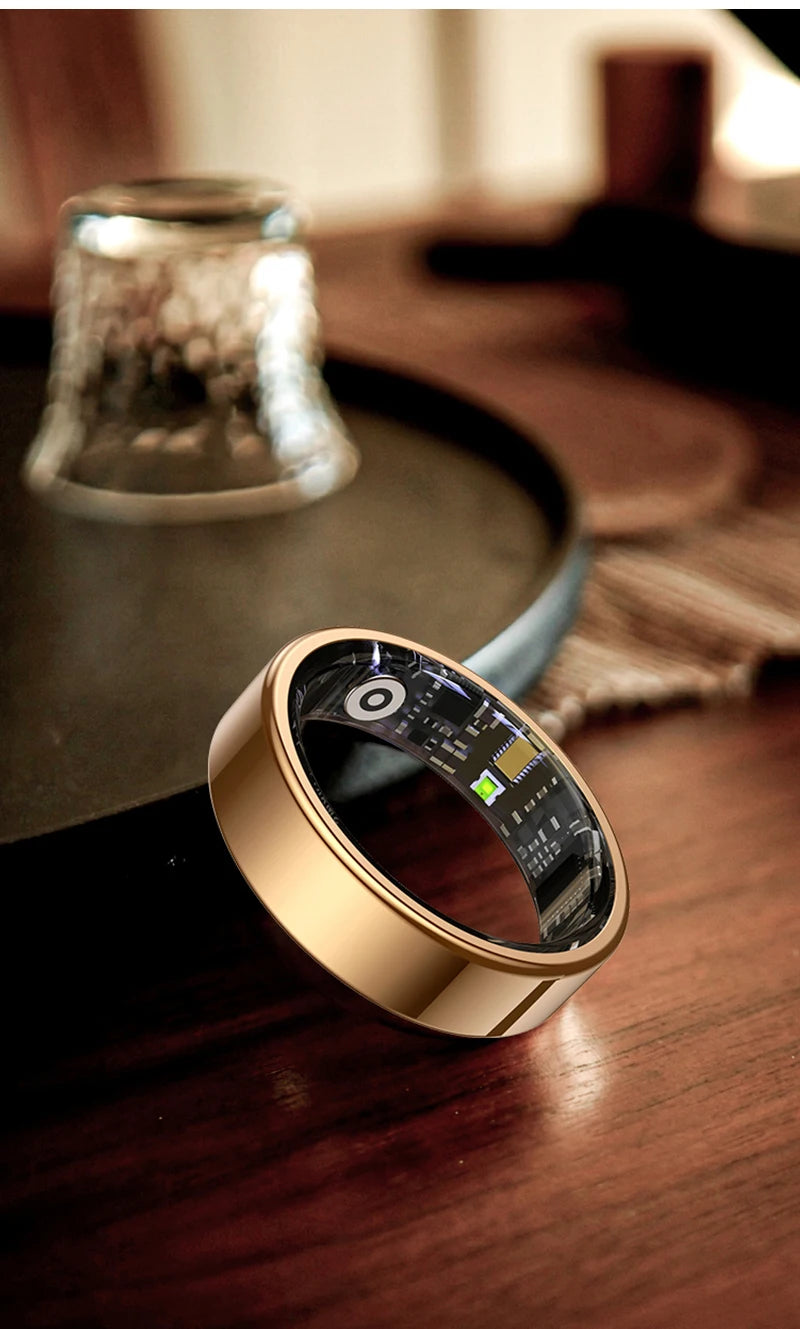 Gold smart health ring with digital display window on a wooden surface
