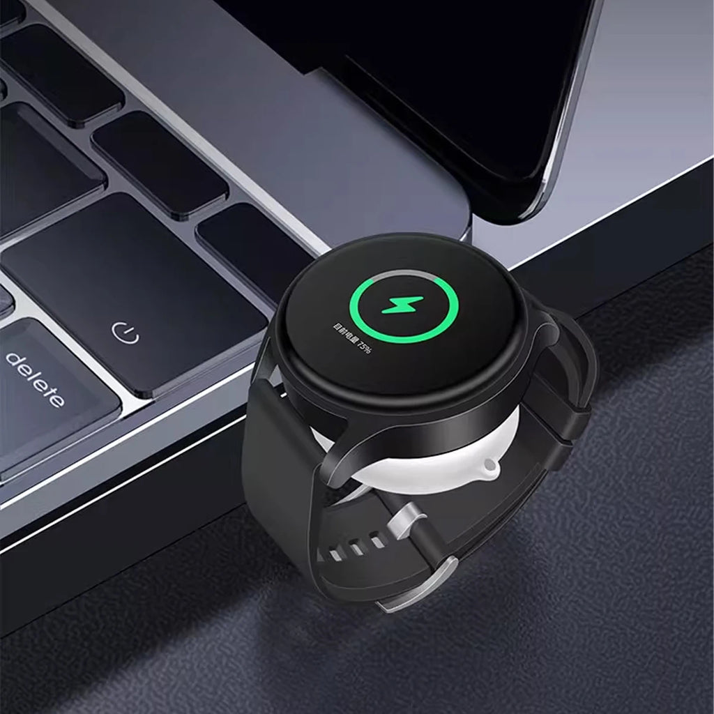 Black smartwatch charging dock stand adapter on laptop keyboard with watch
