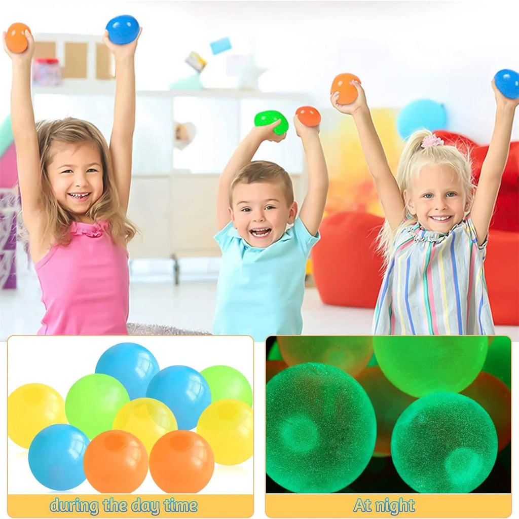 Kids playing with glow sticky balls, holding colorful squishy balls overhead