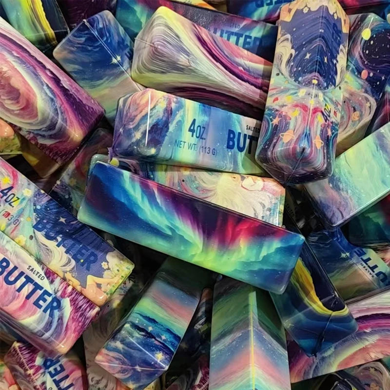 Loose rainbow butter-stick squishy fidget toys stacked together, assorted designs