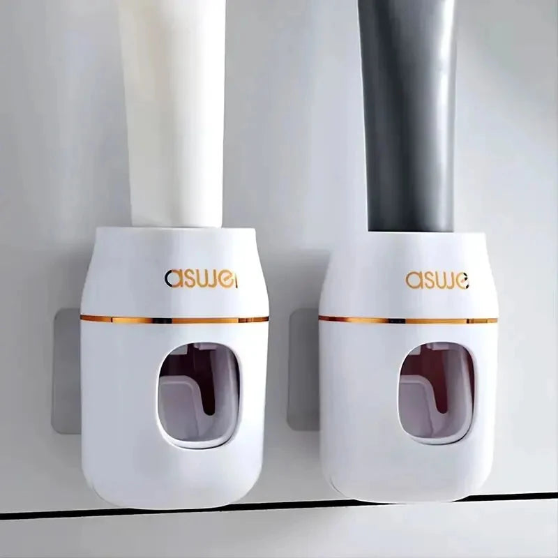 Pair of white automatic toothpaste dispensers mounted on wall with front windows