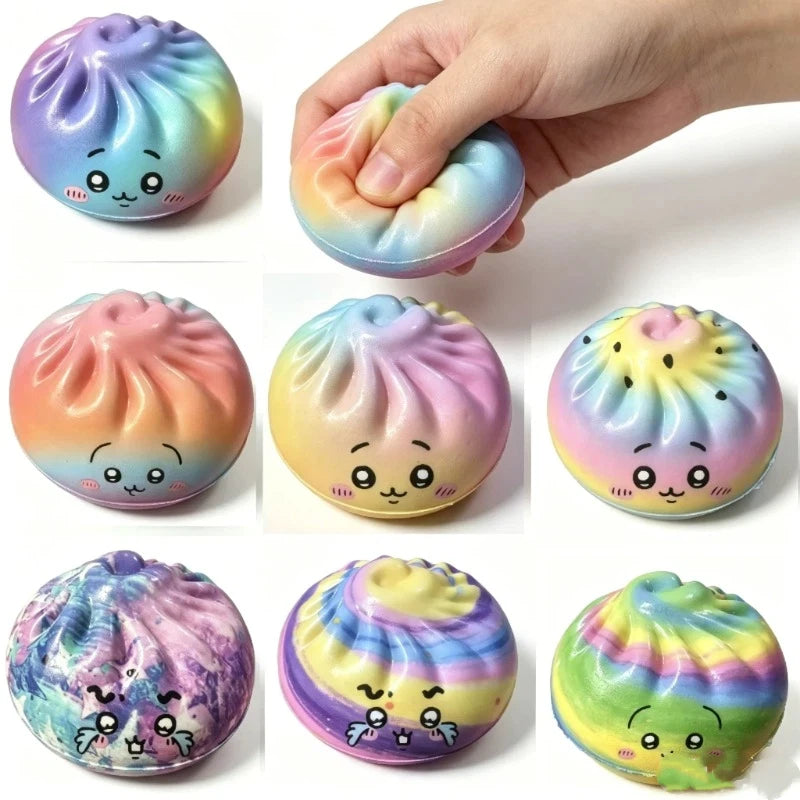 Colorful rainbow dumpling-style squishy toy with cute face, held between fingers