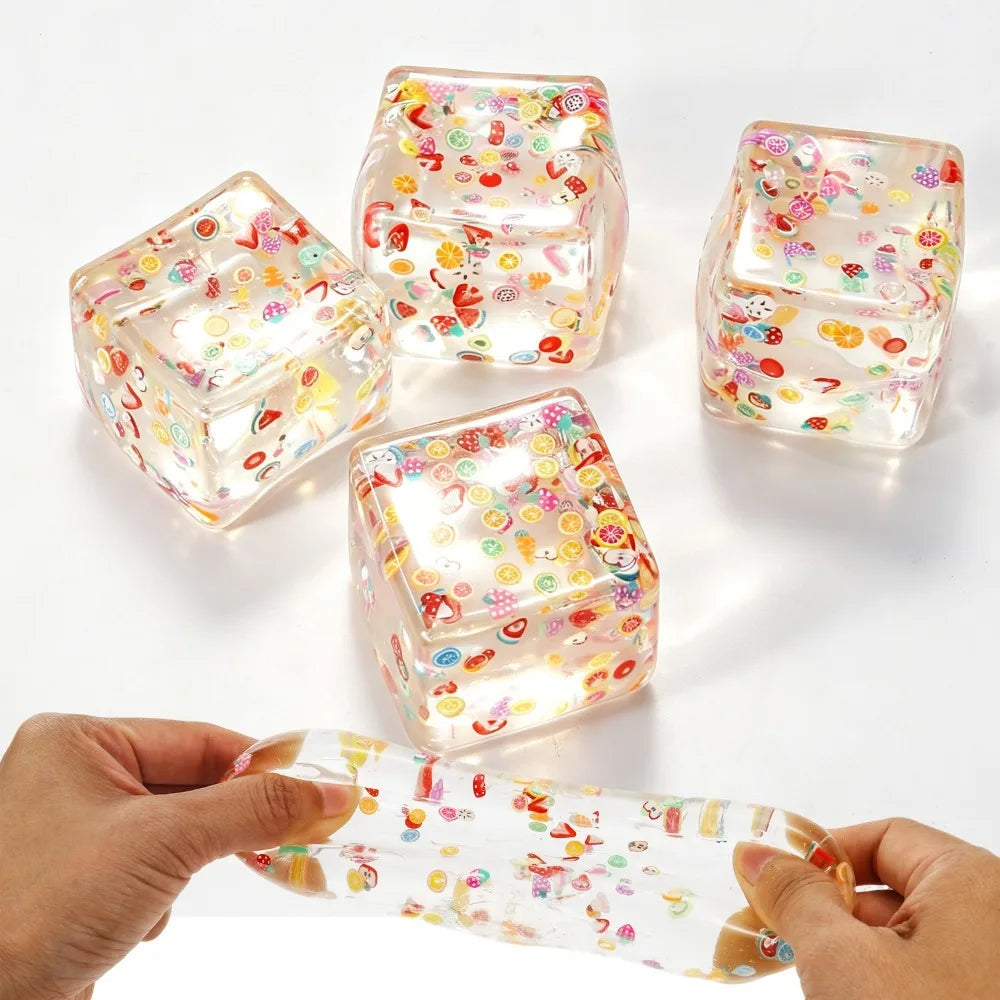 Fruit-themed clear squishy cube stress balls set with a stretched squeeze strip