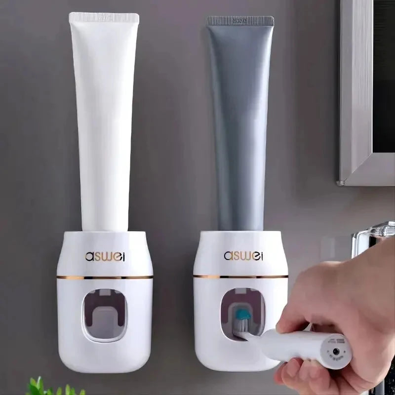 White and gray automatic toothpaste dispensers with push nozzle and toothpaste tube