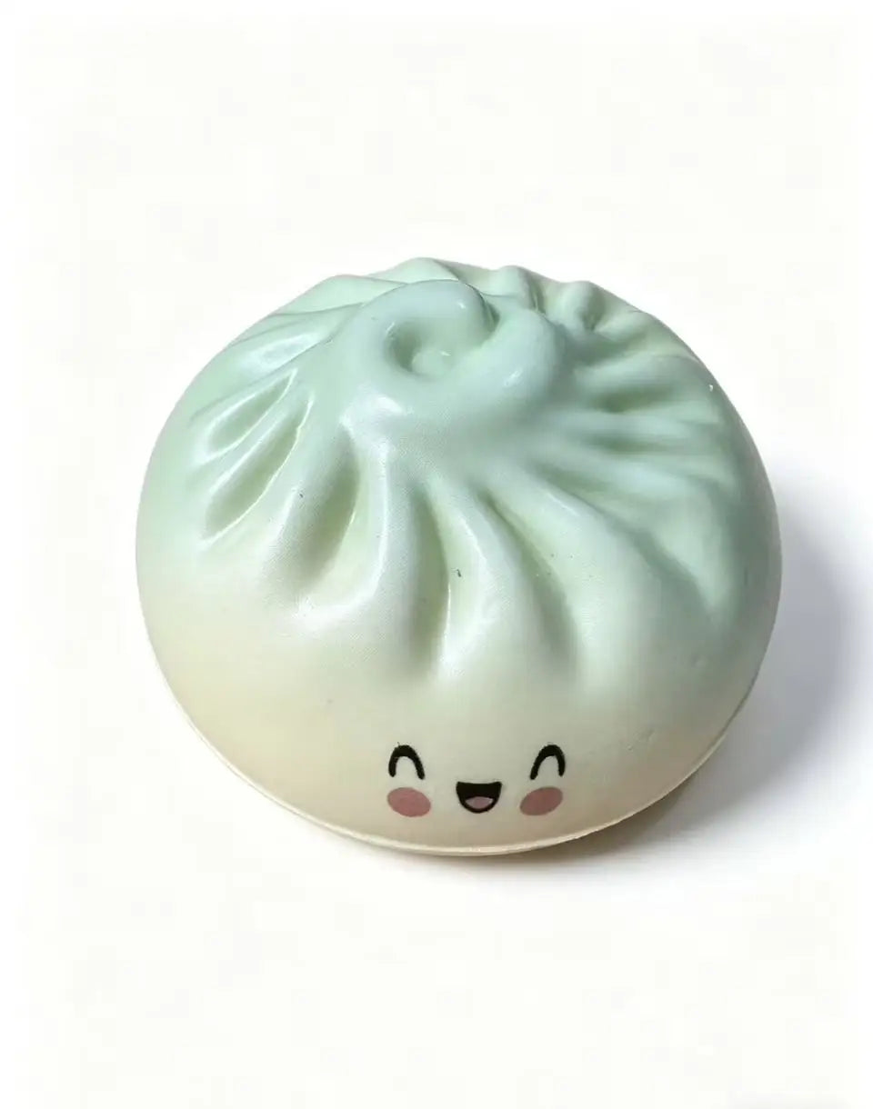 Pastel dumpling squishy toy with ribbed top and smiling face, light mint color.