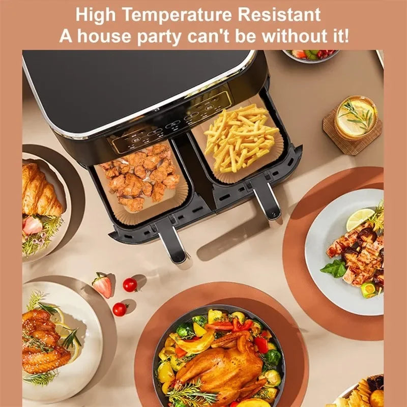 Non-stick air fryer paper liner holding fries and chicken in an air fryer basket