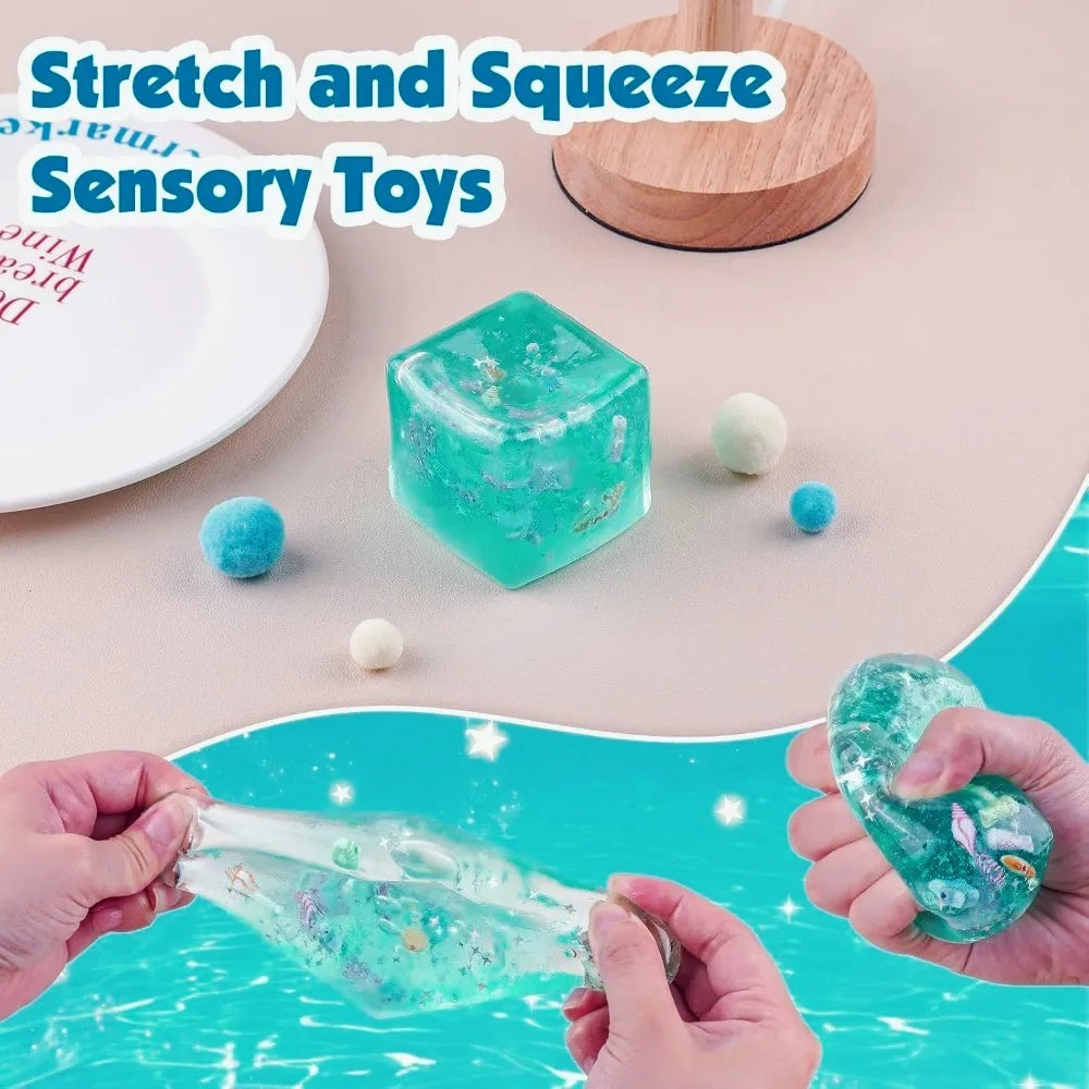 Turquoise squishy stress ball cube on plate, sea-themed details inside, hands squeezing