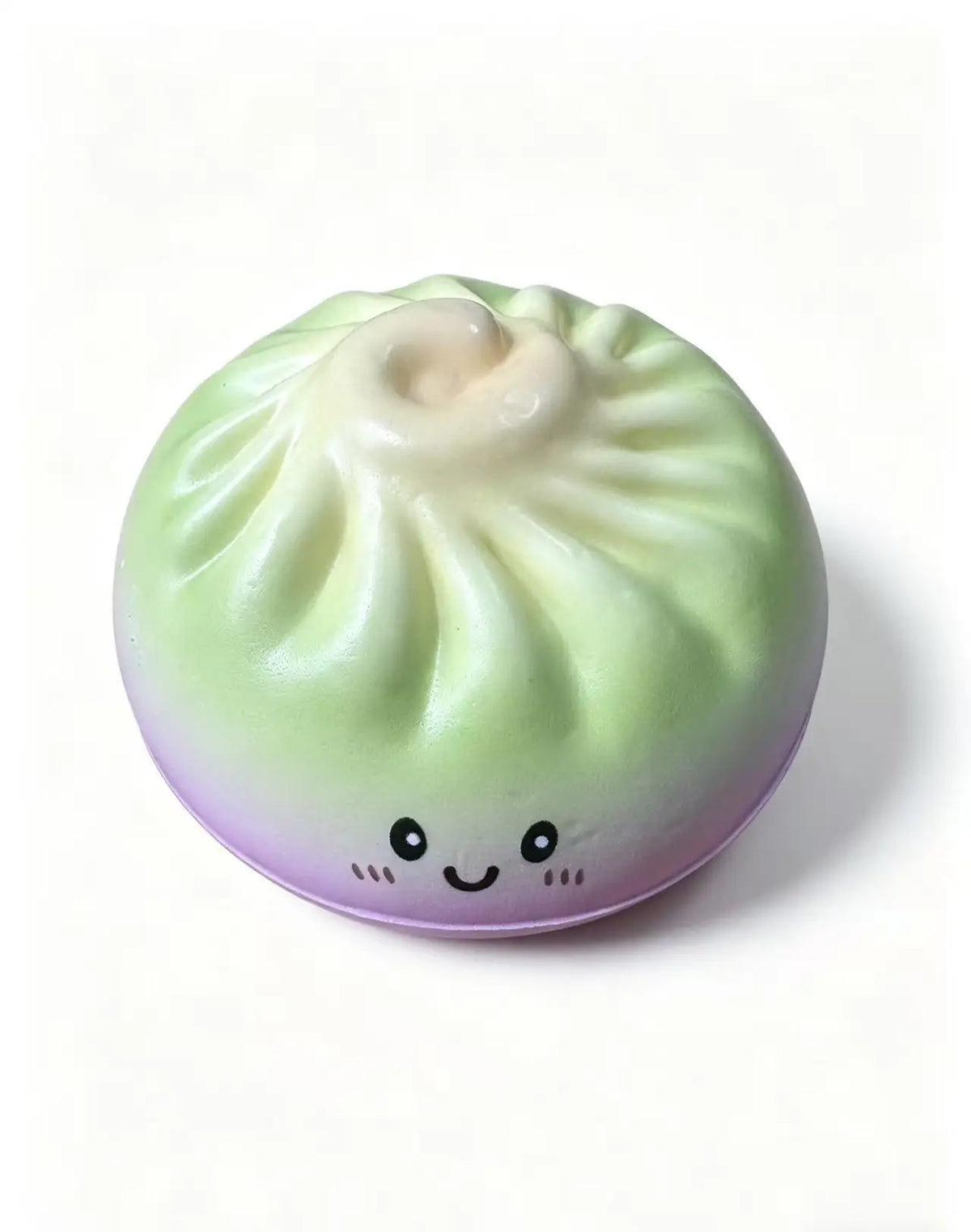 Pastel dumpling squishy toy with ribbed top and smiling face with rosy cheeks.