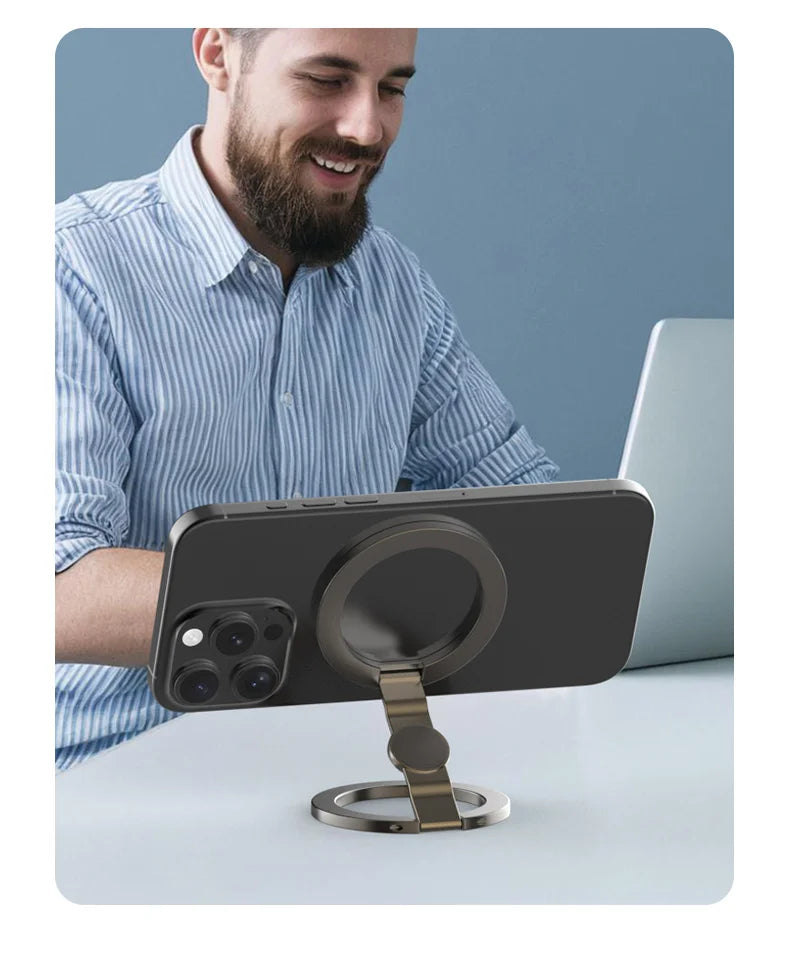 Silver magnetic phone stand supporting a smartphone on a desk