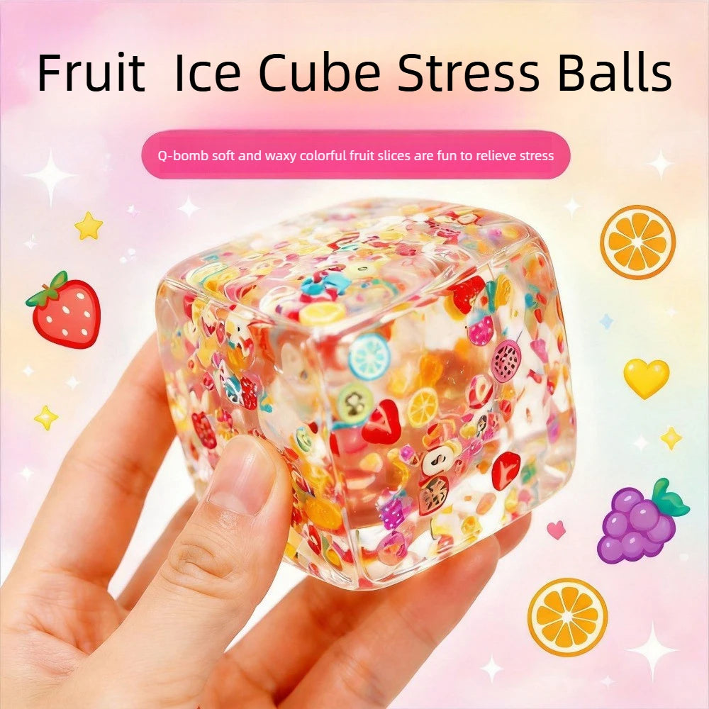 Clear fruit-themed squishy cube stress ball with colorful shapes, close-up in hand