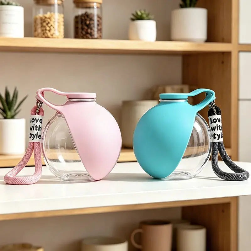 Portable teal and pink pet water bottles with clear chambers and carry straps
