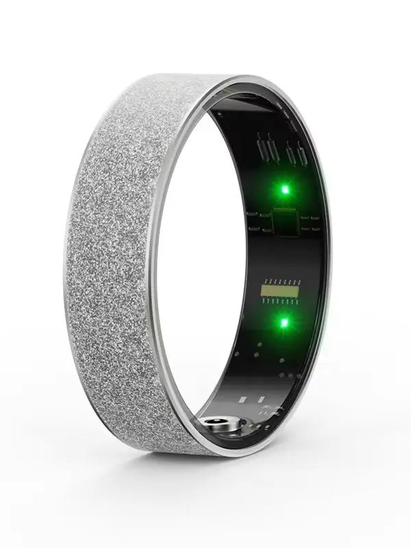Silver textured health tracker ring close-up with green LED lights inside