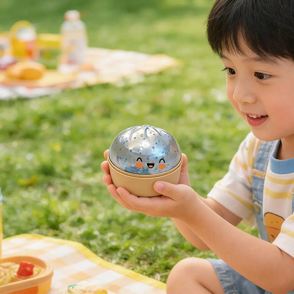Blue glitter squishy dumpling stress ball with face, held by a child outdoors