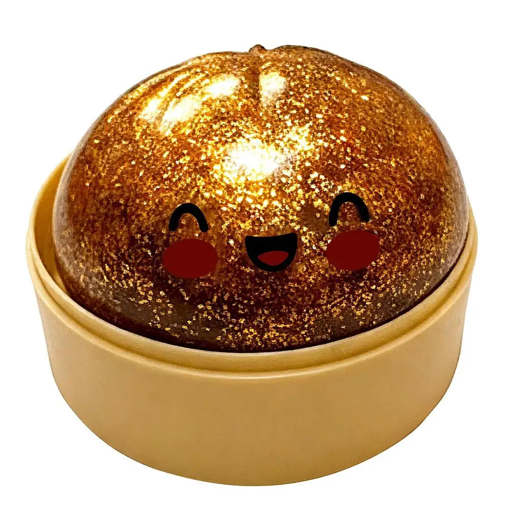 Gold glitter squishy bun stress ball in beige round case, cute face with blush cheeks
