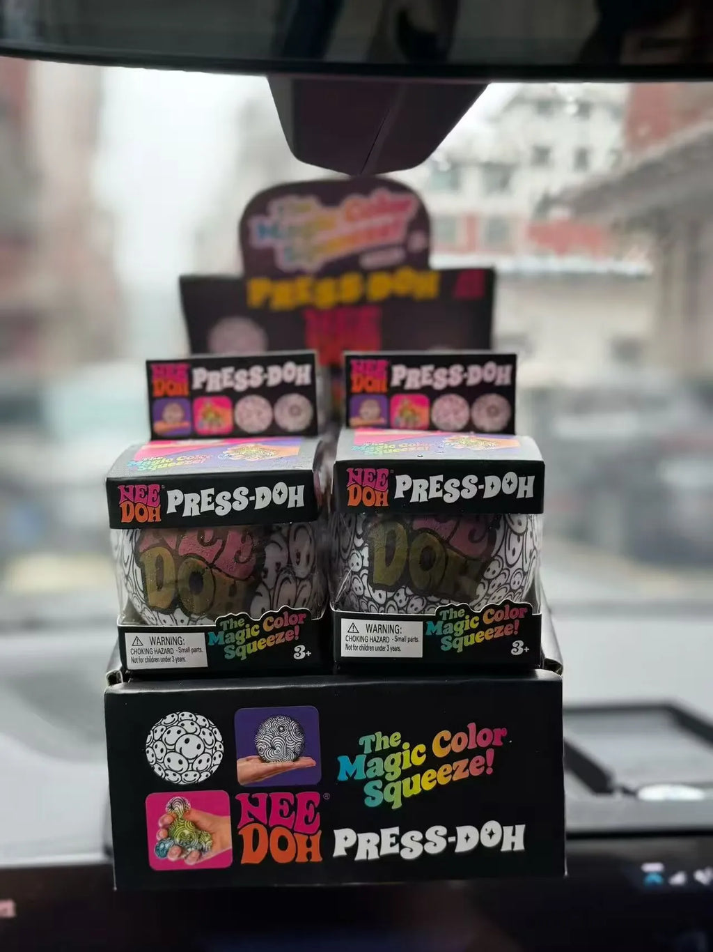 Stack of retail boxes for black-and-white press-and-squeeze stress balls