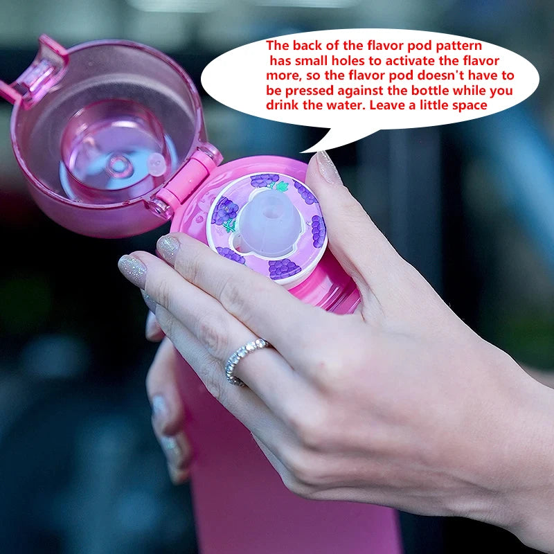 Pink air water bottle with open flavor pod compartment and circular pod insert