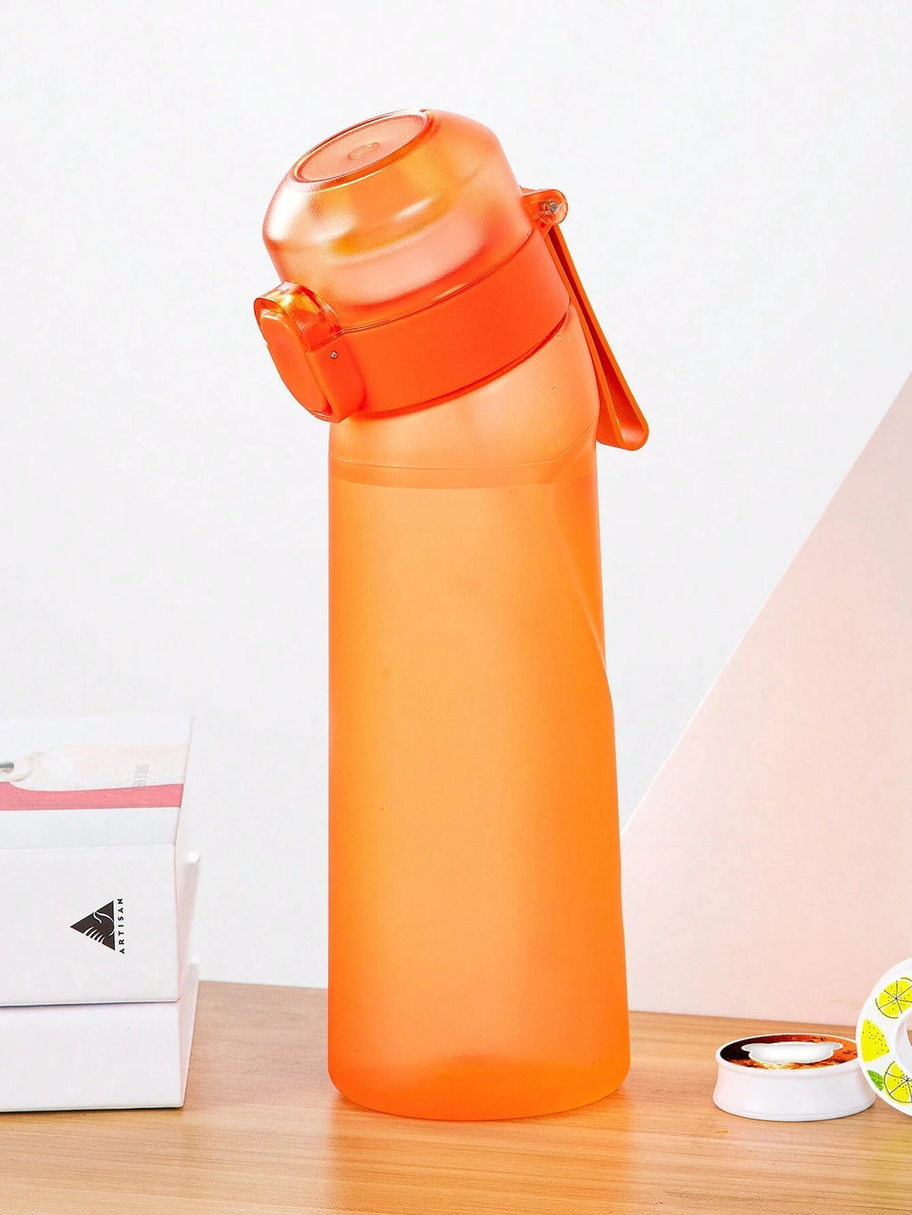 Orange translucent air water bottle with flip top lid and carry handle