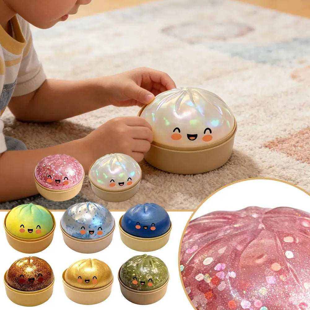 Pink glitter dumpling stress ball and mini set of gold-based balls on a floor