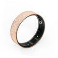 Rose gold textured health tracker ring close-up with black sensor window and green LEDs