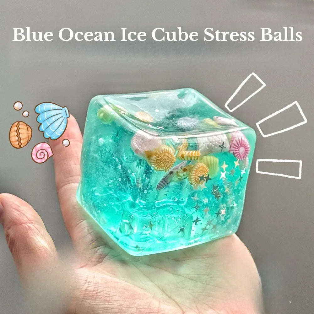 Ocean-themed turquoise squishy stress ball cube with sea creatures inside, held in hand
