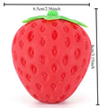 Red strawberry-shaped squishy stress ball with green leaf detail and raised texture