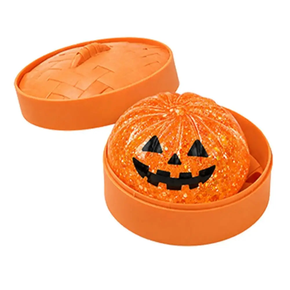 Orange glitter pumpkin squishy stress ball in orange round case, Halloween face