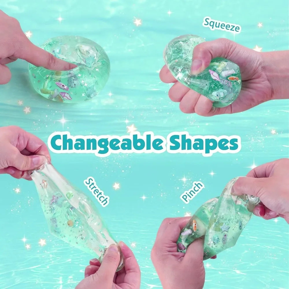 Turquoise squishy stress ball cube being stretched in hands, ocean confetti and sea creatures inside