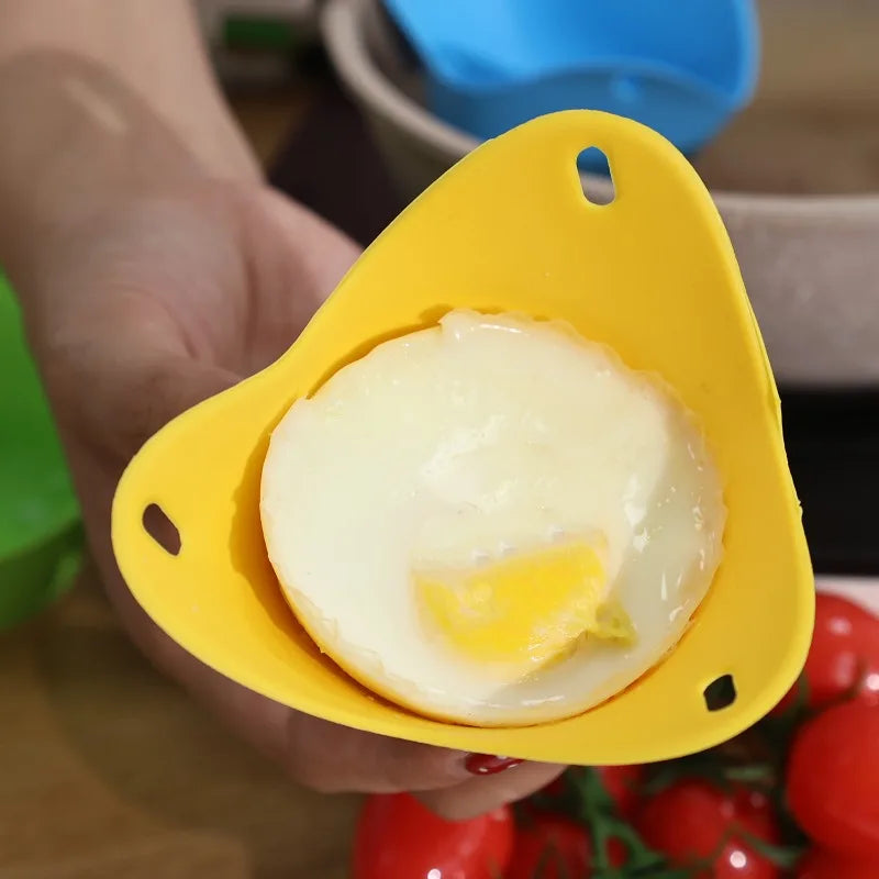 Yellow silicone egg poacher cup with a cooked egg, held in a hand.