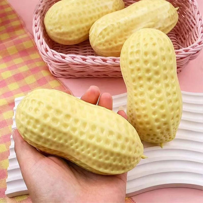 Yellow peanut-shaped squishy stress toy with dotted texture in pink basket
