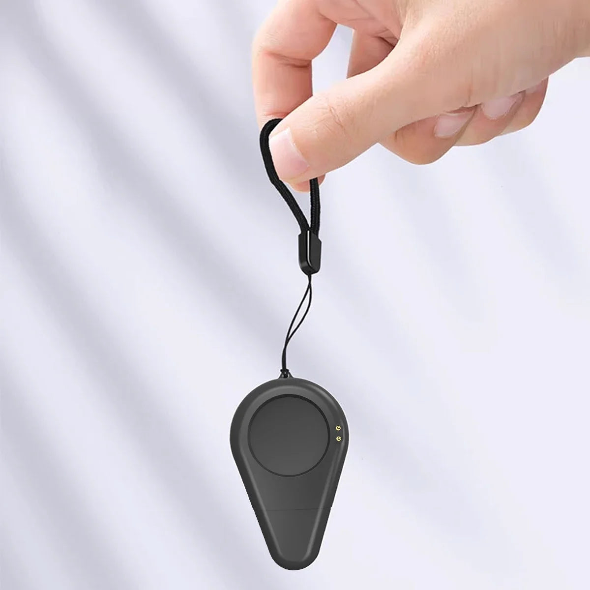 Black smartwatch charging dock stand adapter held in hand with hanging cable