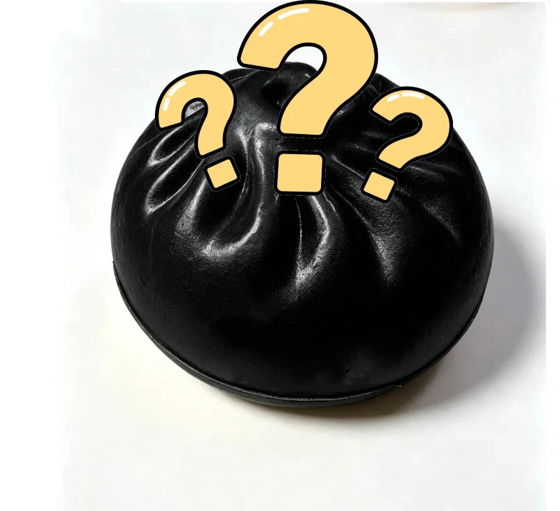 Black dumpling squishy toy with large yellow question marks graphic