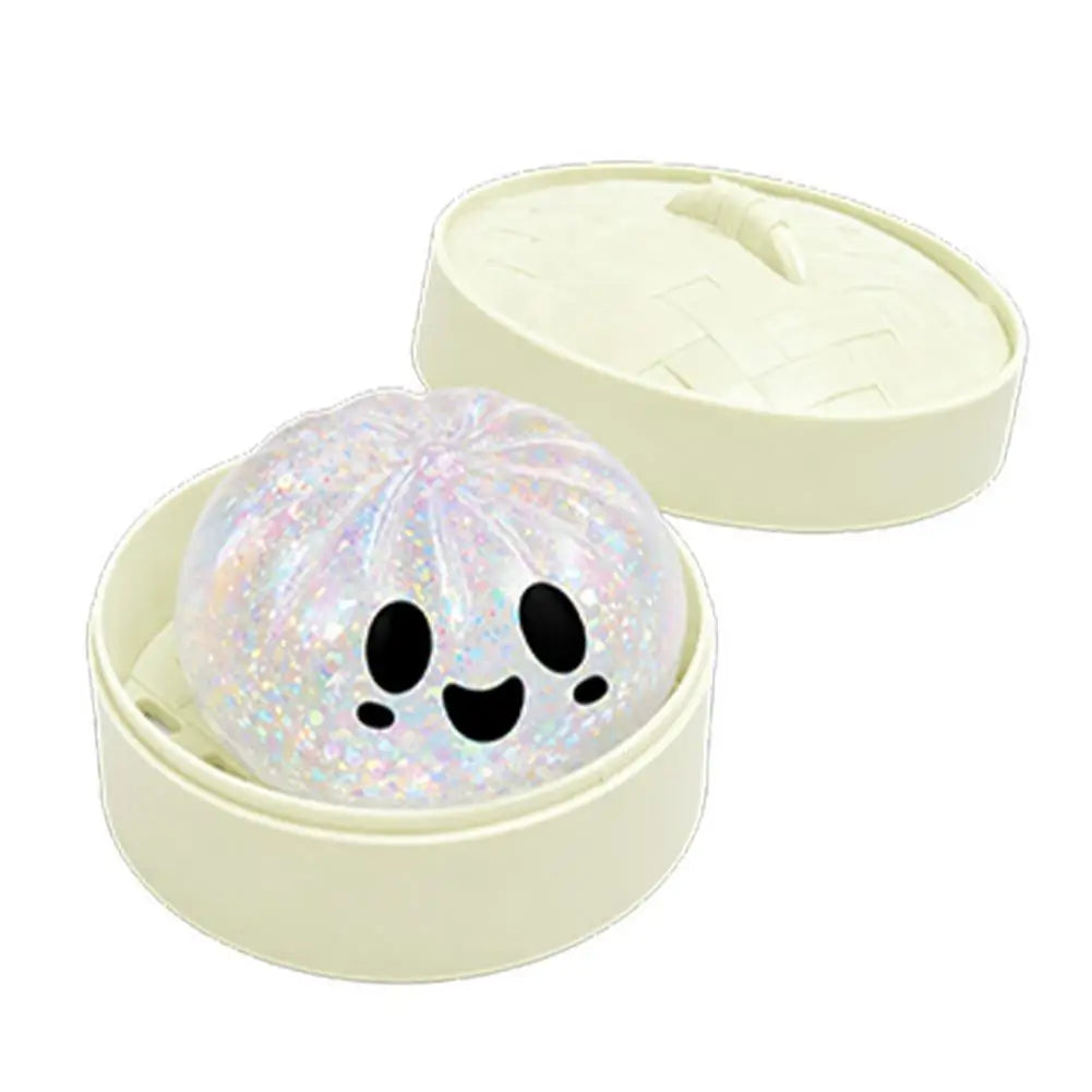 Glittery white squishy bun stress ball in pale green round storage case, smiling face
