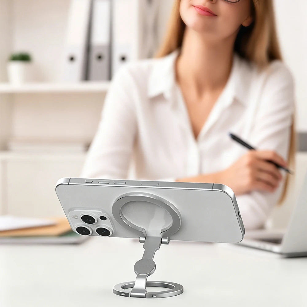 Silver magnetic phone ring holder mounted on a smartphone with foldable stand
