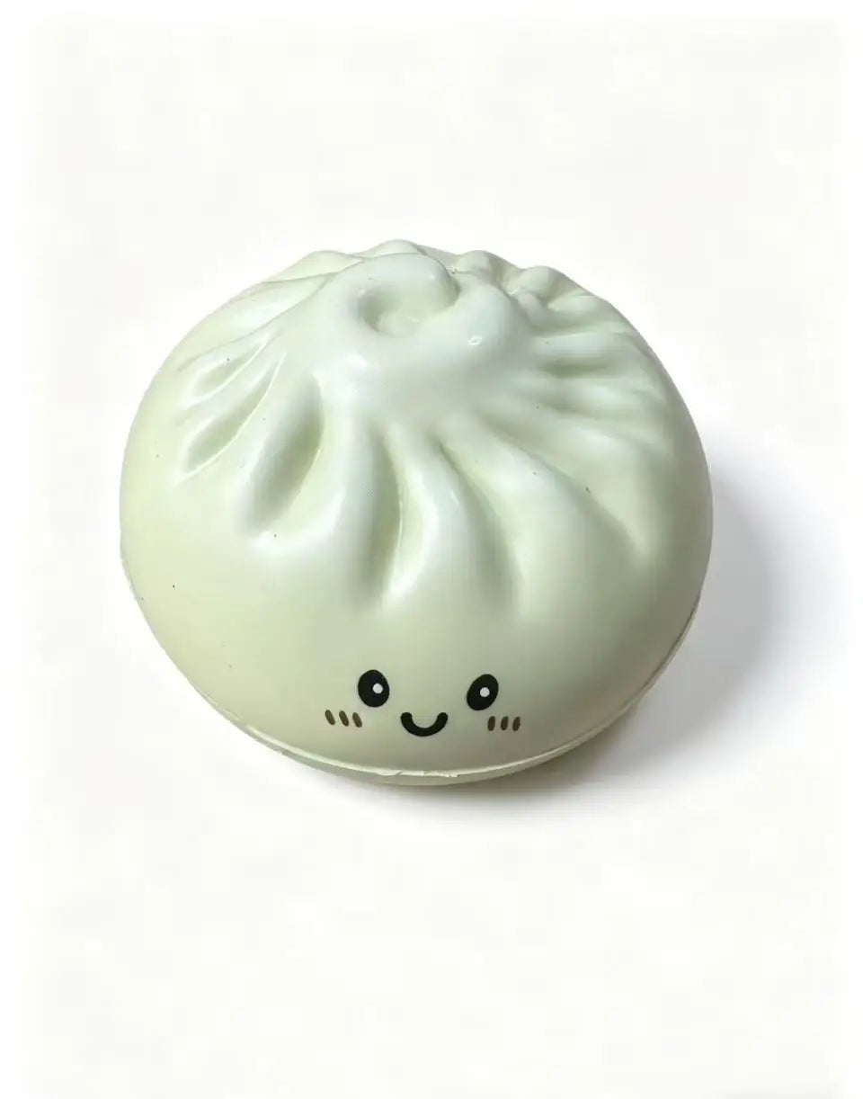 Light green dumpling-shaped squishy stress-relief toy with smiling face