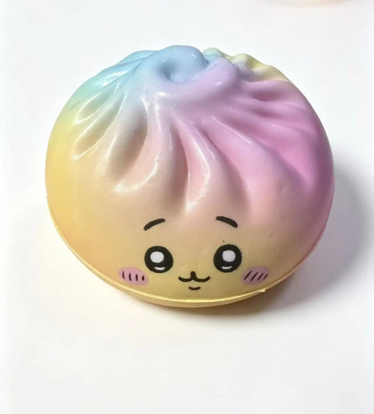 Pastel rainbow dumpling-shaped squishy stress-relief toy with cute face