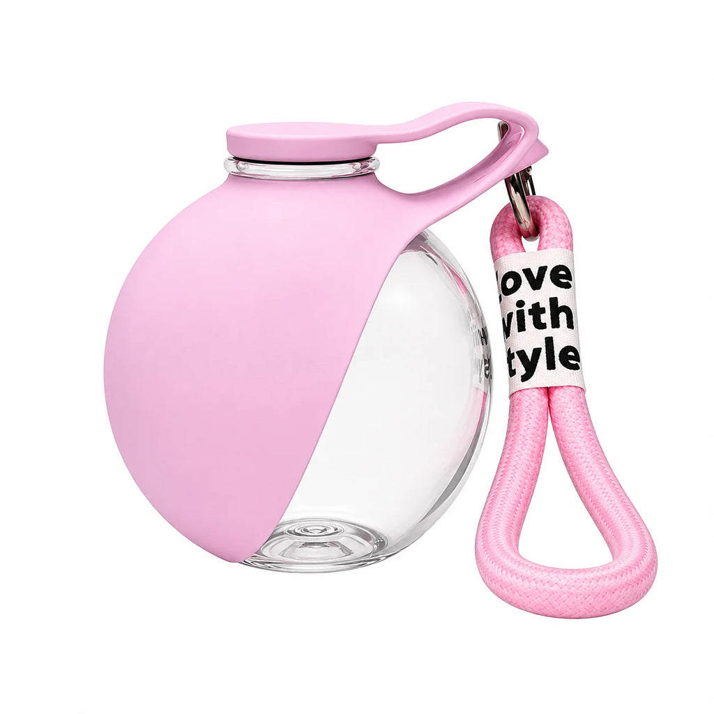 Pink pet water dispenser bottle with hinged clear drinking cup and handle strap