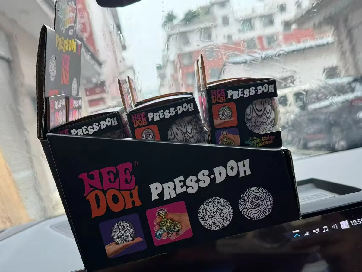 Retail display box featuring black-and-white press-and-squeeze stress ball designs