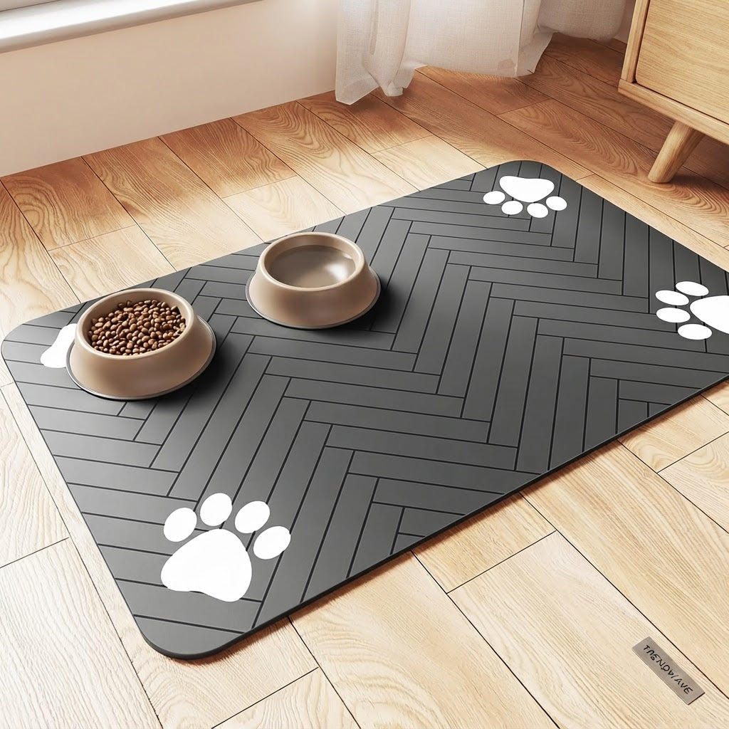 Dark gray pet feeding mat with white paw-print border and two stainless feeding bowls