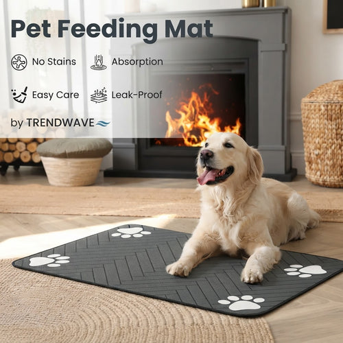 Dark gray pet feeding mat with white paw-print corners on a hardwood floor