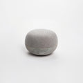 Light gray spherical fabric speaker with perforated bottom grille