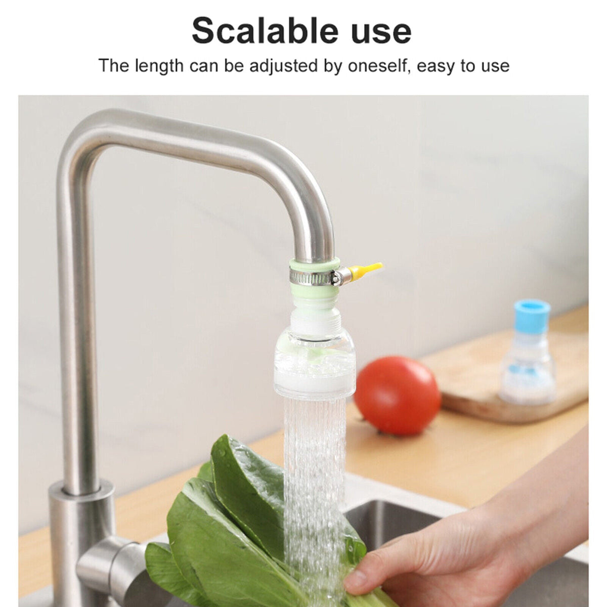 Clear plastic faucet extender attached to a silver kitchen faucet with water spray